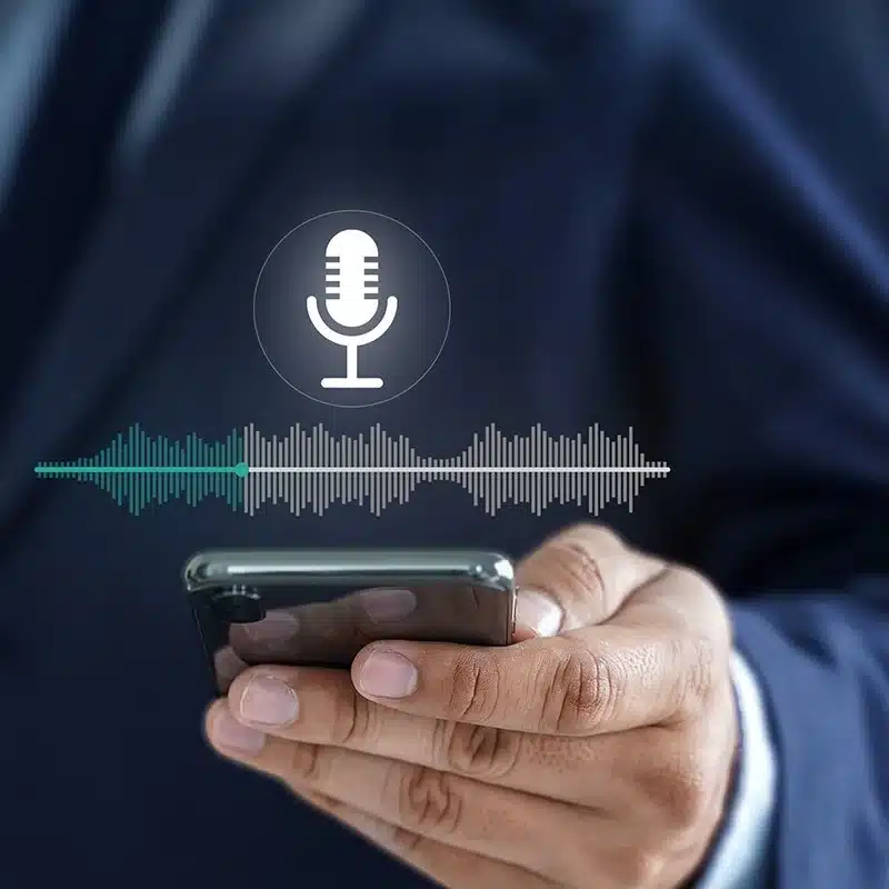 Man holding a phone and giving a speech